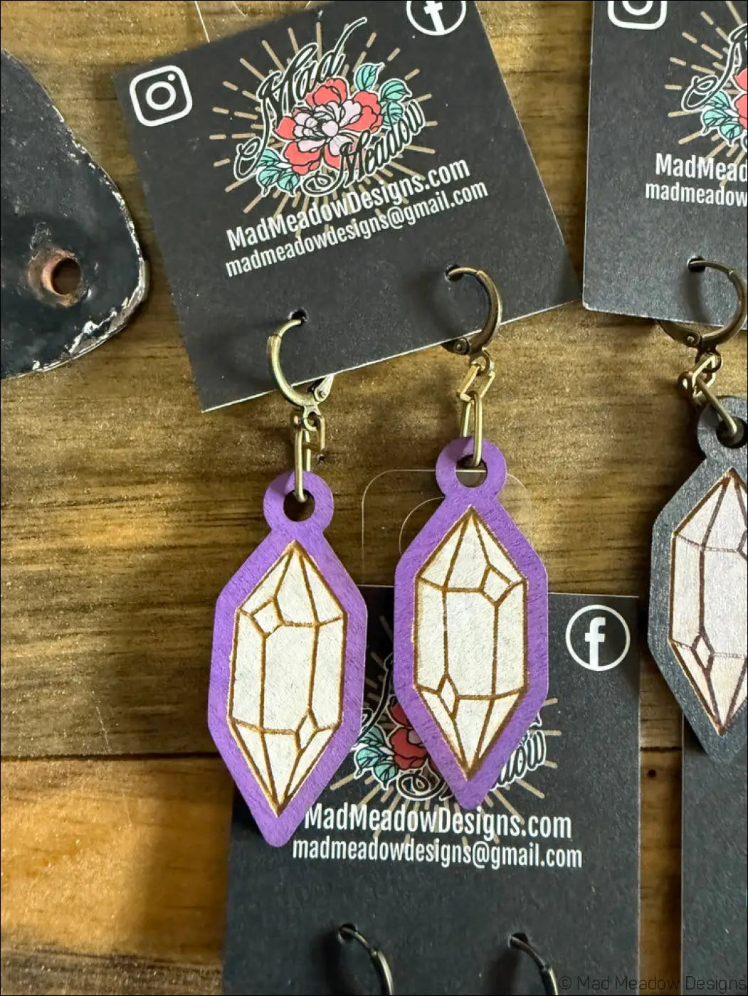 Purple and white crystal hand-painted wooden earrings with gold outlines and geometric shapes