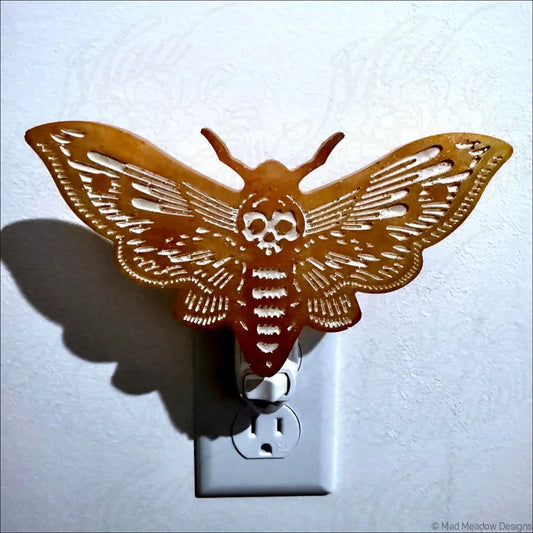 Golden death moth resin wall night light features a copper gold feather wall night design with skull detail on plug-in base