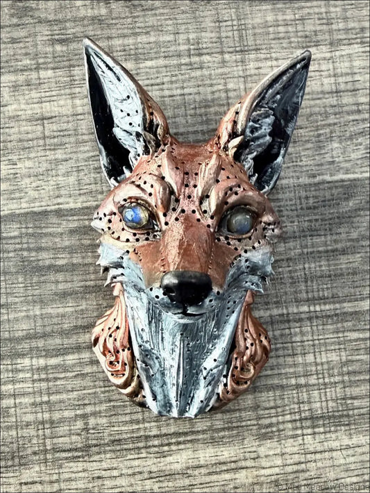 A detailed red fox wall sculpture with natural labradorite eyes and copper silver resin on textured fur