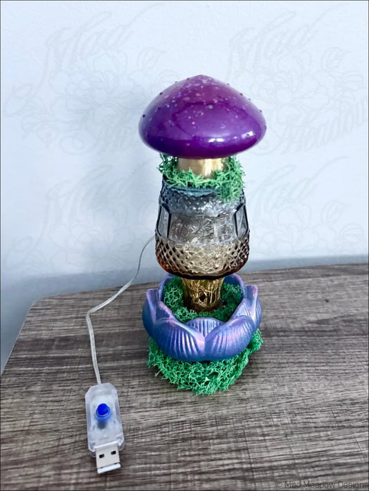 Purple mushroom-shaped glass bud vase with translucent cap gold stem and moss base USB light