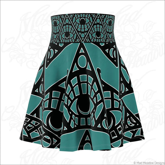 Teal and black tribal skater skirt with mystic eye geometric print and printed care label visible on the back side