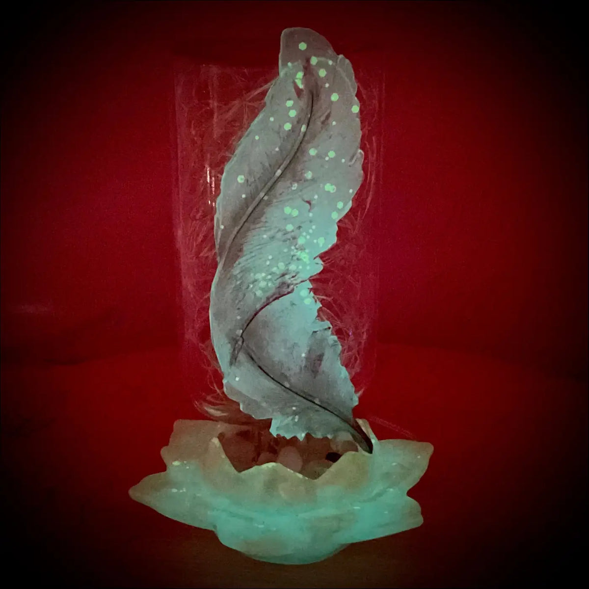 Silver feather sculpture with glowing dots in a clear antique glass apothecary bottle on teal lotus flower base usb light