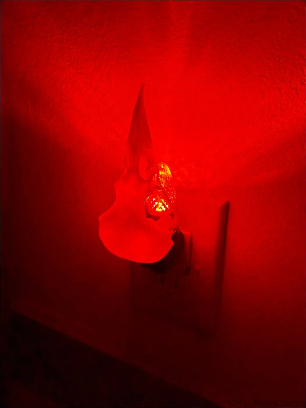 Red glowing nightlight shaped like a guitar featured in the white bird skull wall night light with vibrant purple hues