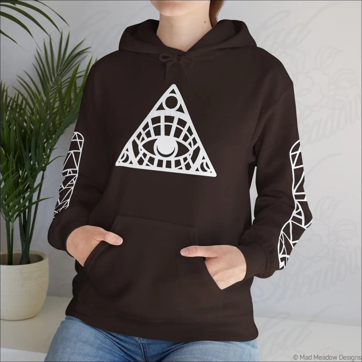 Black hoodie with white all-seeing eye triangle design and patterned sleeves featuring kangaroo pouch care instructions tumble dry