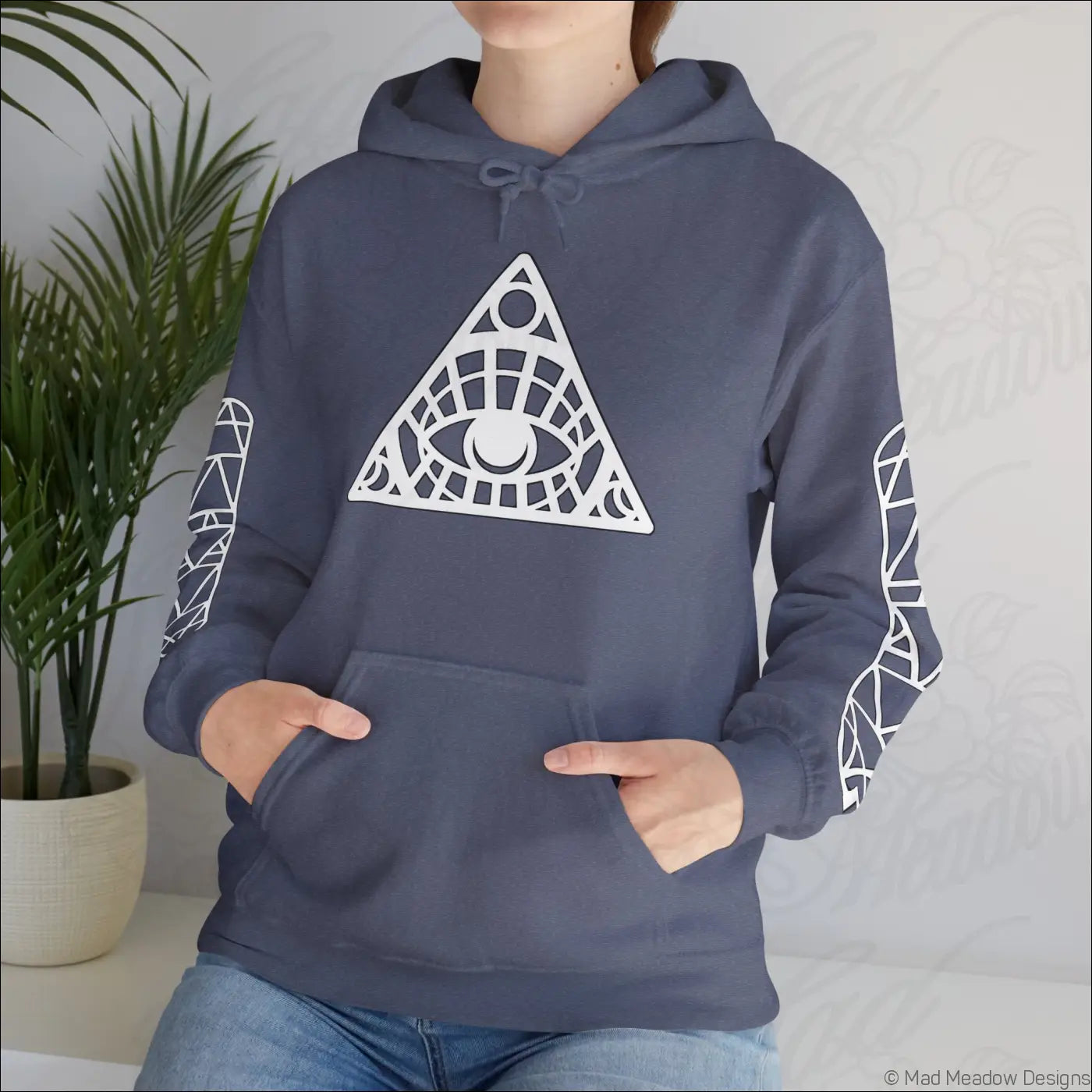 Navy blue all-seeing eye triangle hoodie with white geometric eye design, patterned sleeves, kangaroo pouch, tumble dry care instructions