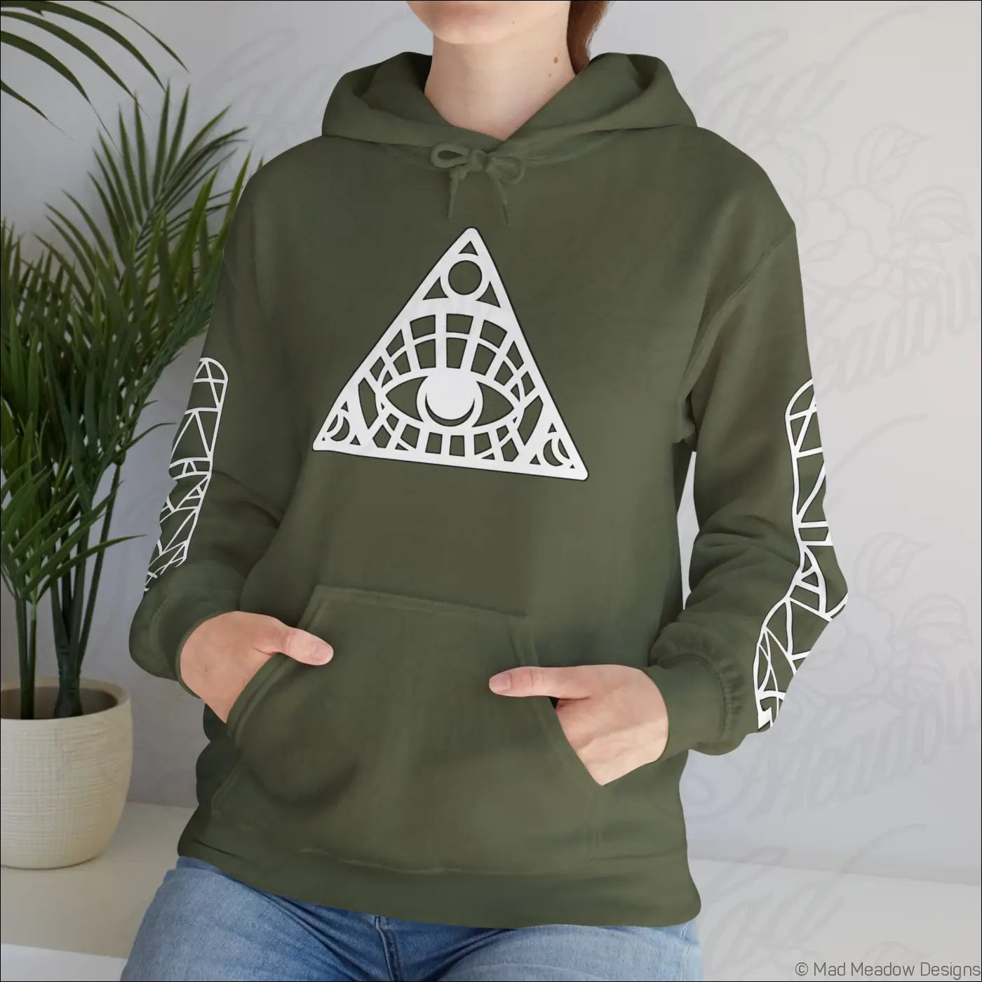Olive green all-seeing eye triangle hoodie with white geometric design, patterned sleeves, kangaroo pouch, care instructions to tumble dry safe