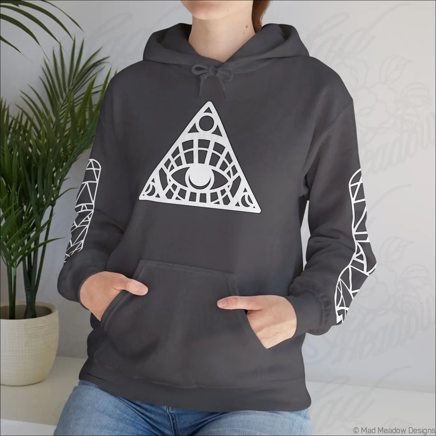 Dark gray all-seeing eye triangle hoodie with geometric eye design, patterned sleeves, kangaroo pouch, tumble dry care instructions