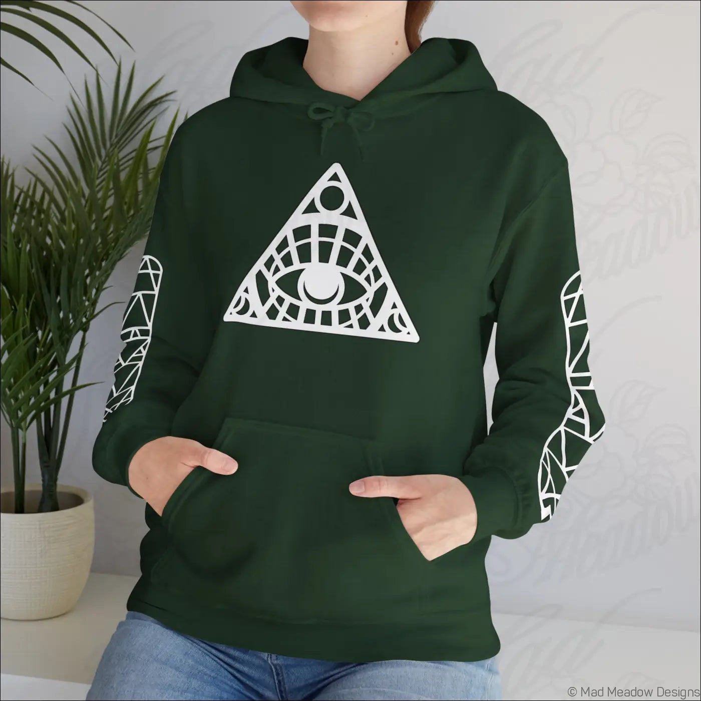 Dark green all-seeing eye triangle hoodie with geometric design, kangaroo pouch, and care instructions to tumble dry
