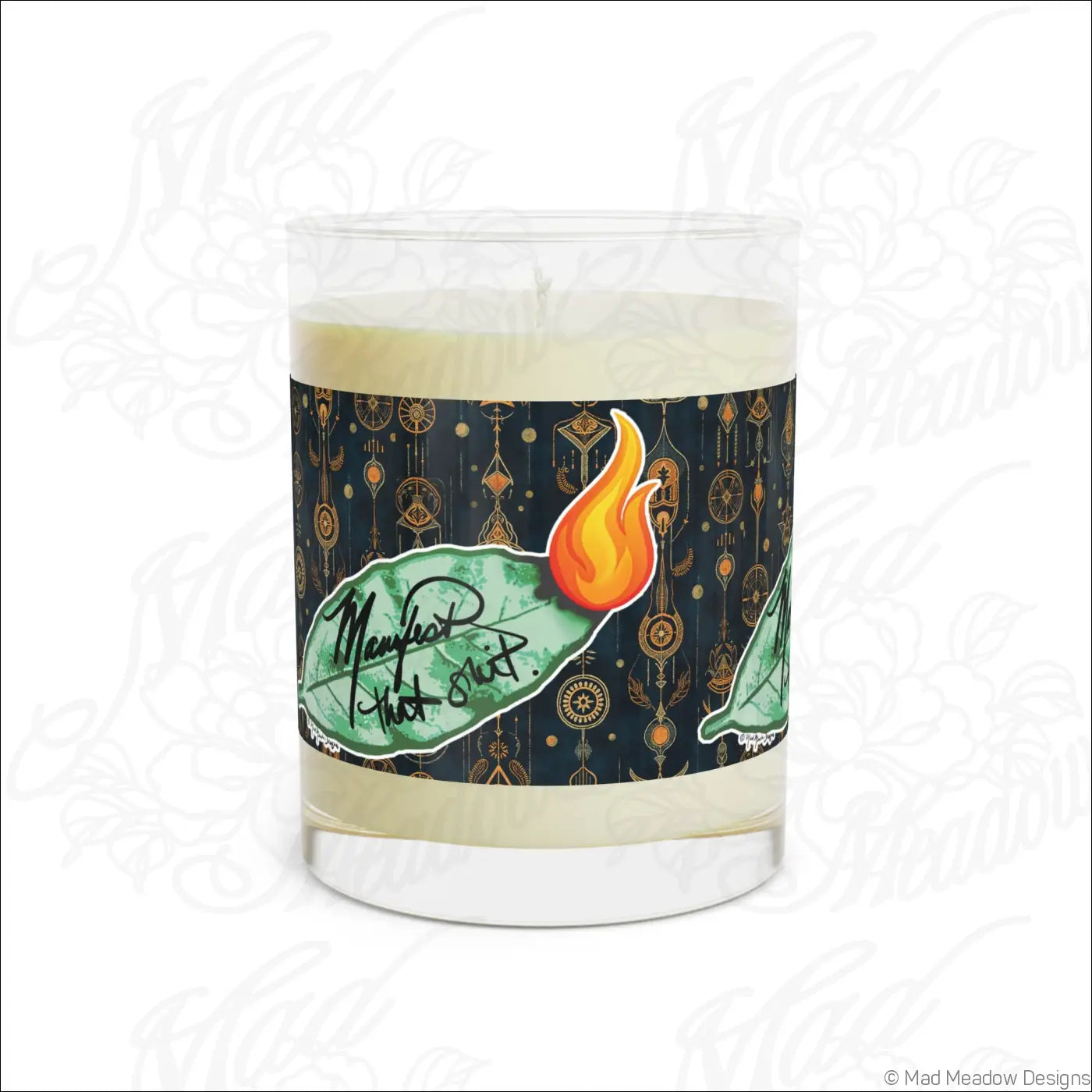 A clear glass candle jar with creamy white wax and a dark blue label featuring gold patterns and bay leaf design