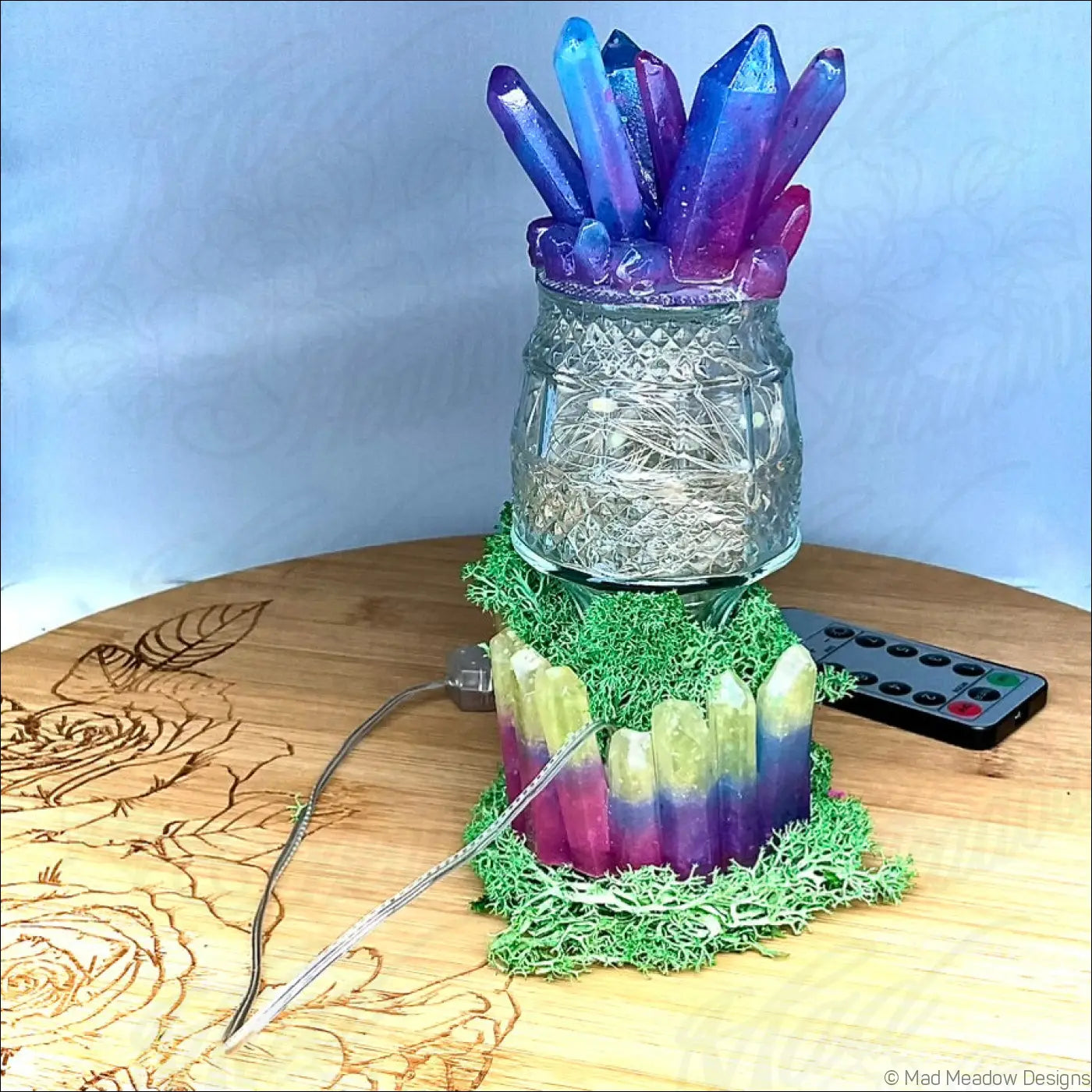 A captivating crystal and moss usb light with clear patterned glass base and vibrant purple to blue gradient crystals