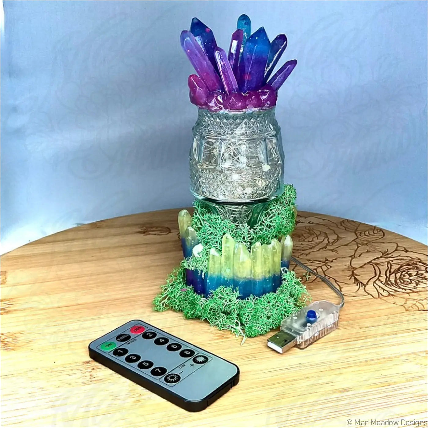 Captivating crystal and moss usb light with clear glass base purple and blue crystals and green moss accents