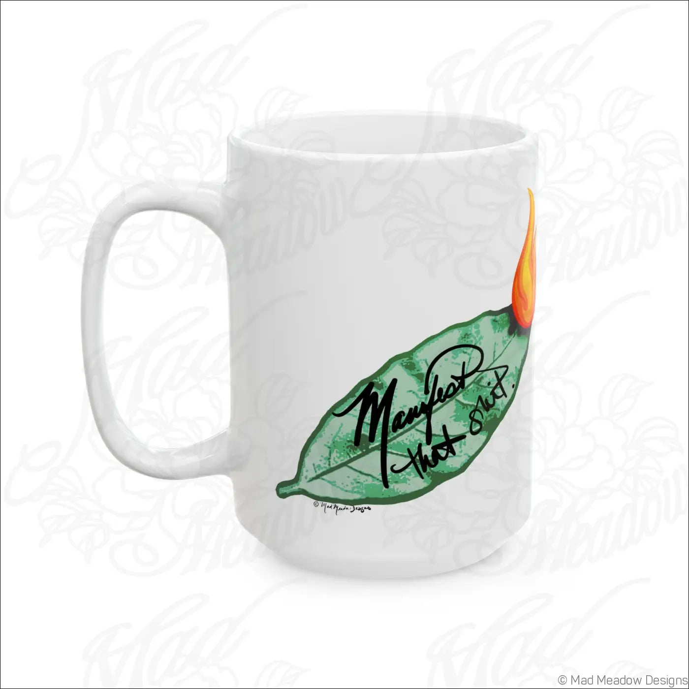 Glossy white ceramic mug with a comfortable c-handle featuring hand-drawn flaming leaf art and manifest that shot text