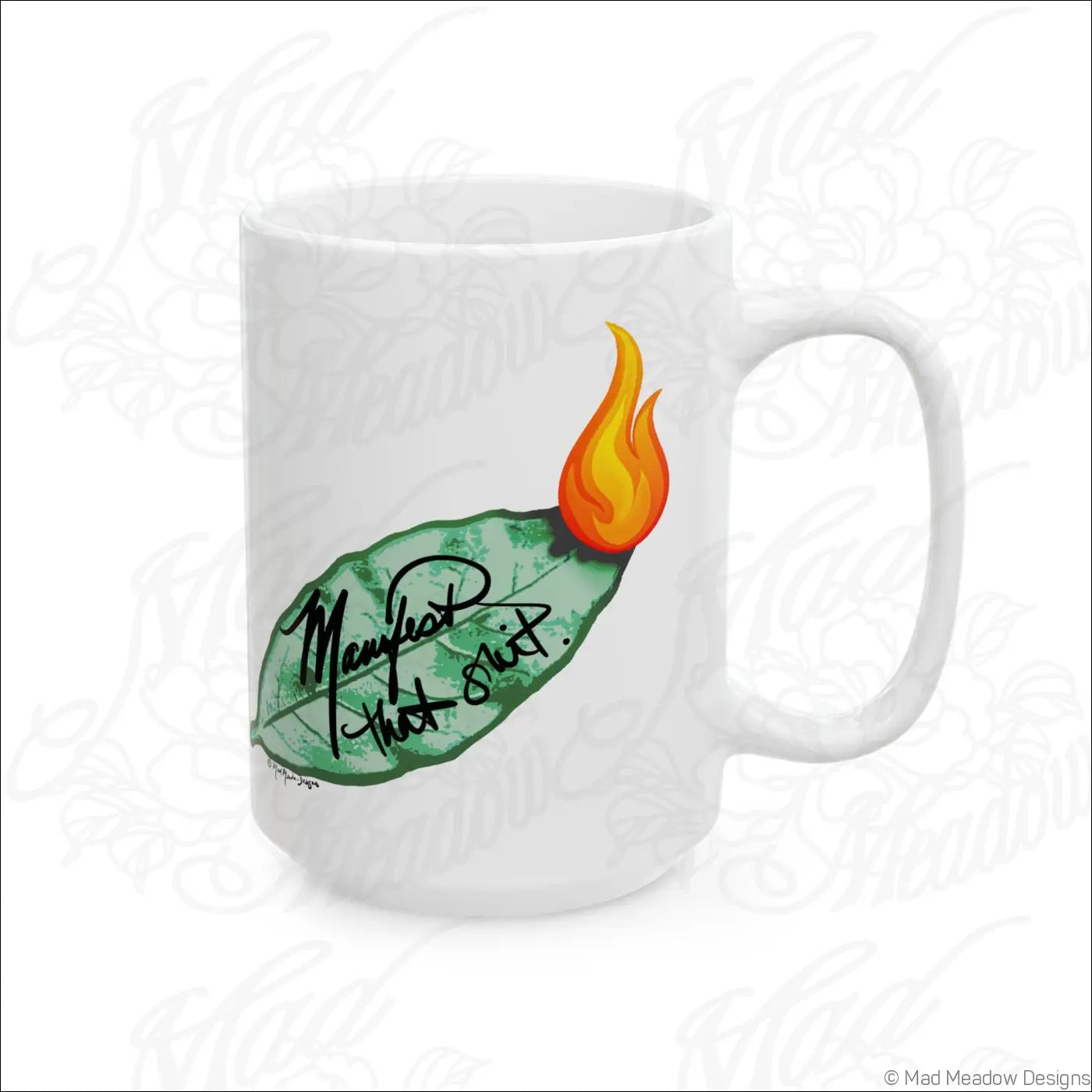Glossy white ceramic mug with comfortable c-handle featuring hand-drawn green leaf and orange flame art manifest that shit phrase