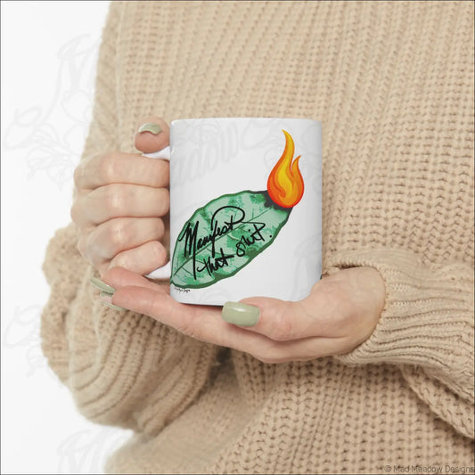 Glossy white ceramic mug with comfortable c-handle featuring hand-drawn flaming leaf and mend that shit script