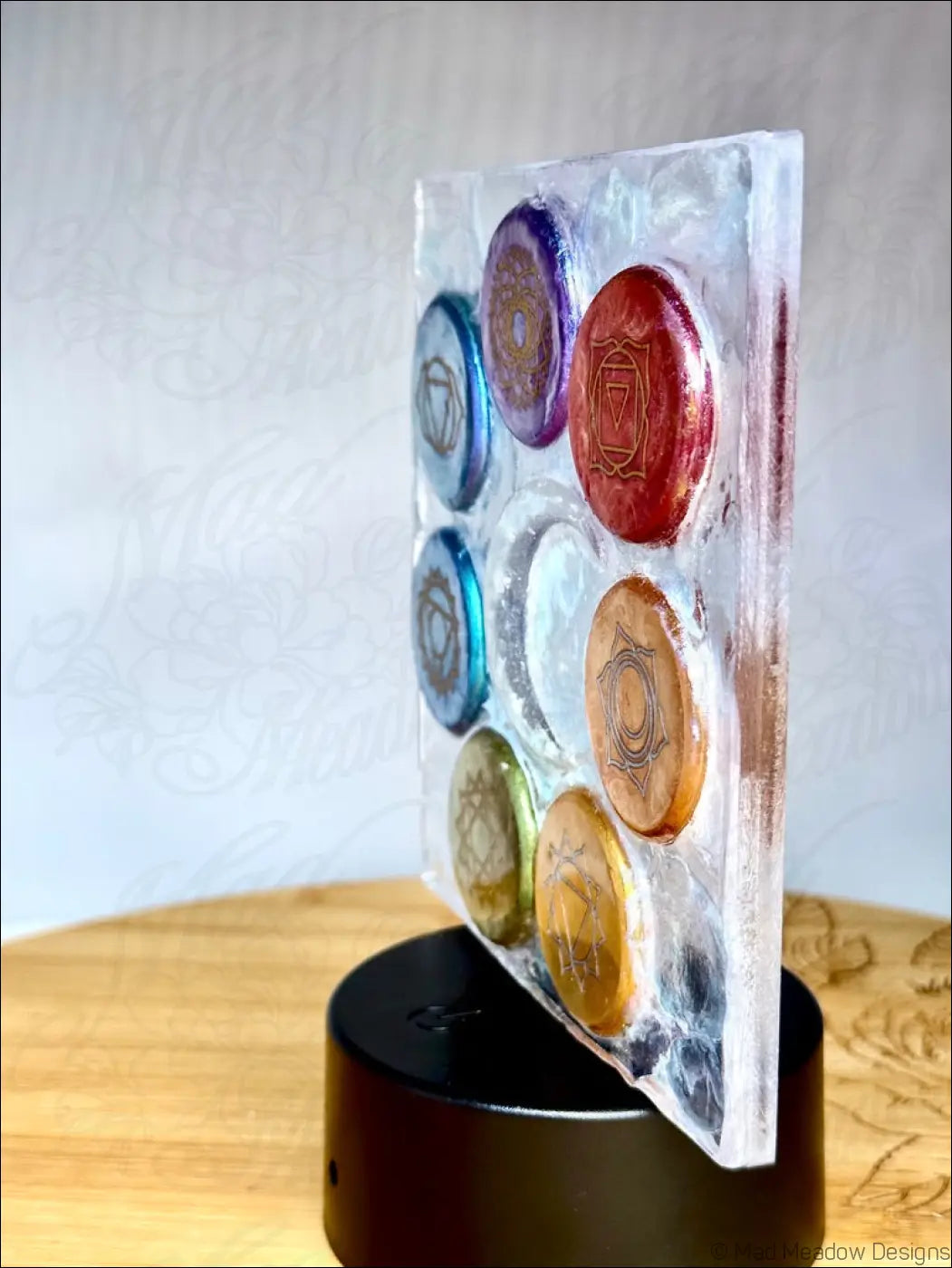 Clear acrylic chakra night light with seven rainbow-colored disks arranged in a glowing crescent moon base