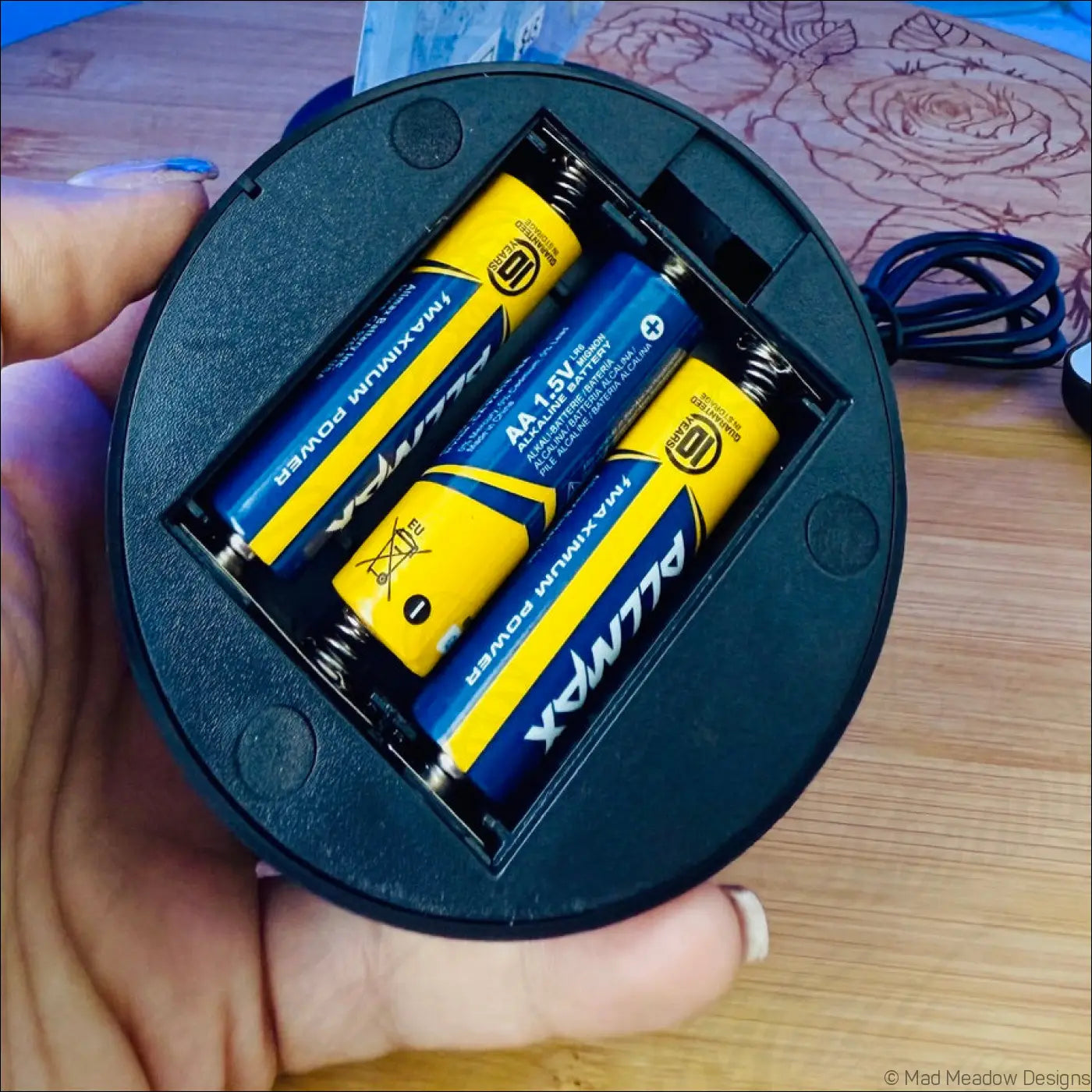Back of chakra night light showing black battery compartment with four aa maximum power batteries inside