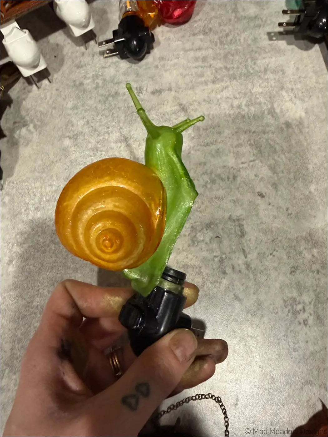 Charming snail night light with vibrant green and amber glossy translucent shell perfect for a whimsical wonderland