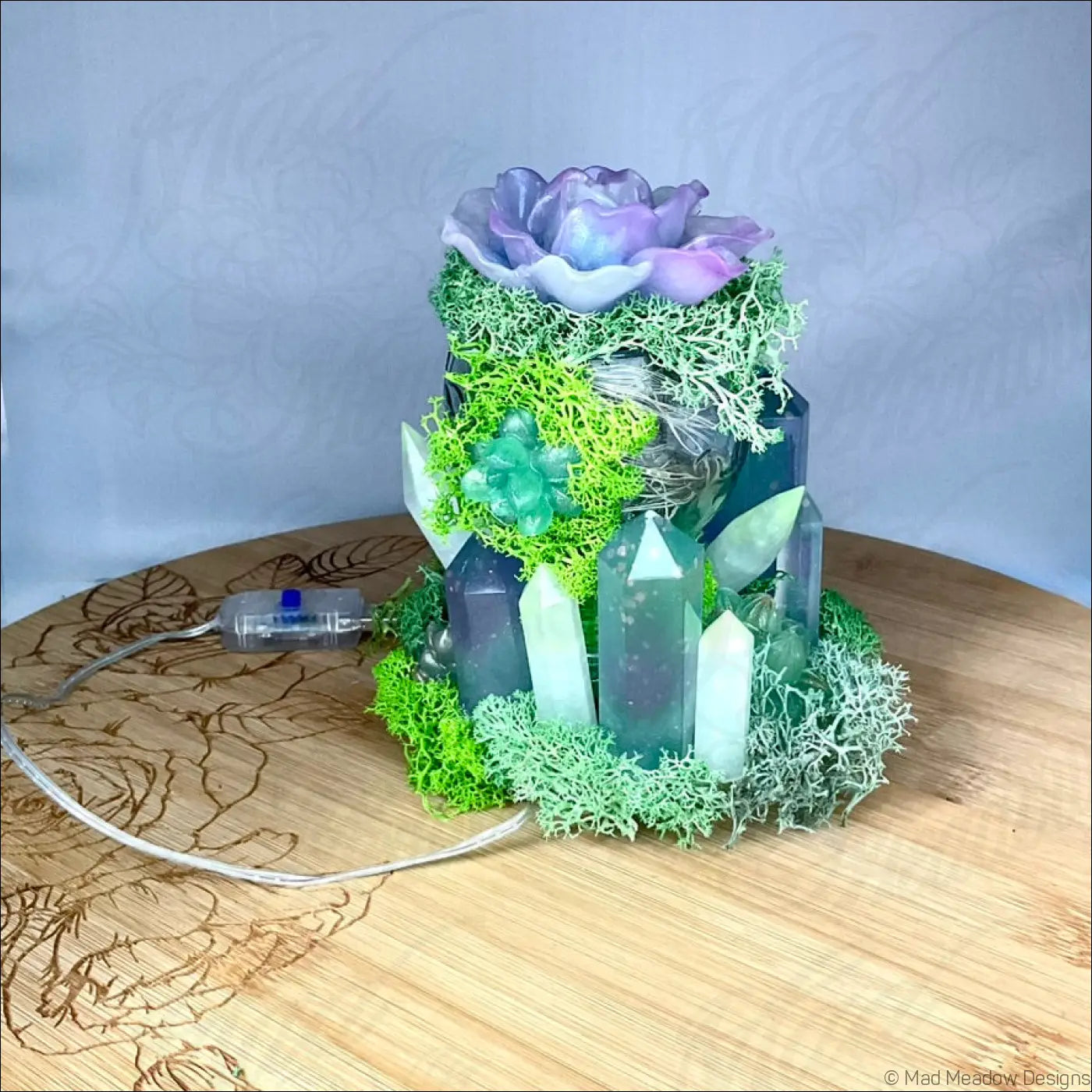 A usb powered vintage glass bottle light with purple flower moss and crystal pillars for decorative use