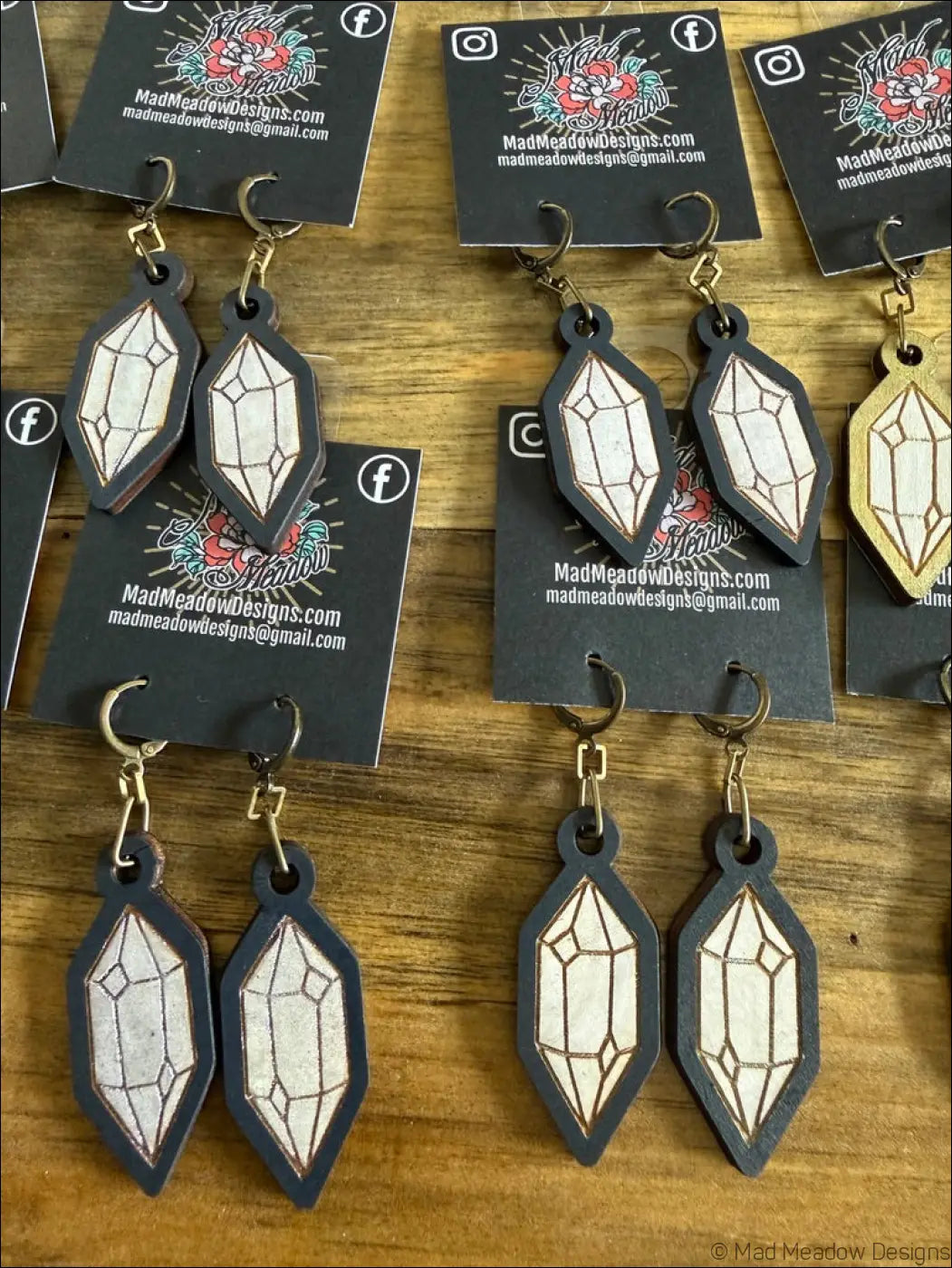 Black leather wooden earrings with white crystal hand-painted designs and gold-tone hooks for stylish wear
