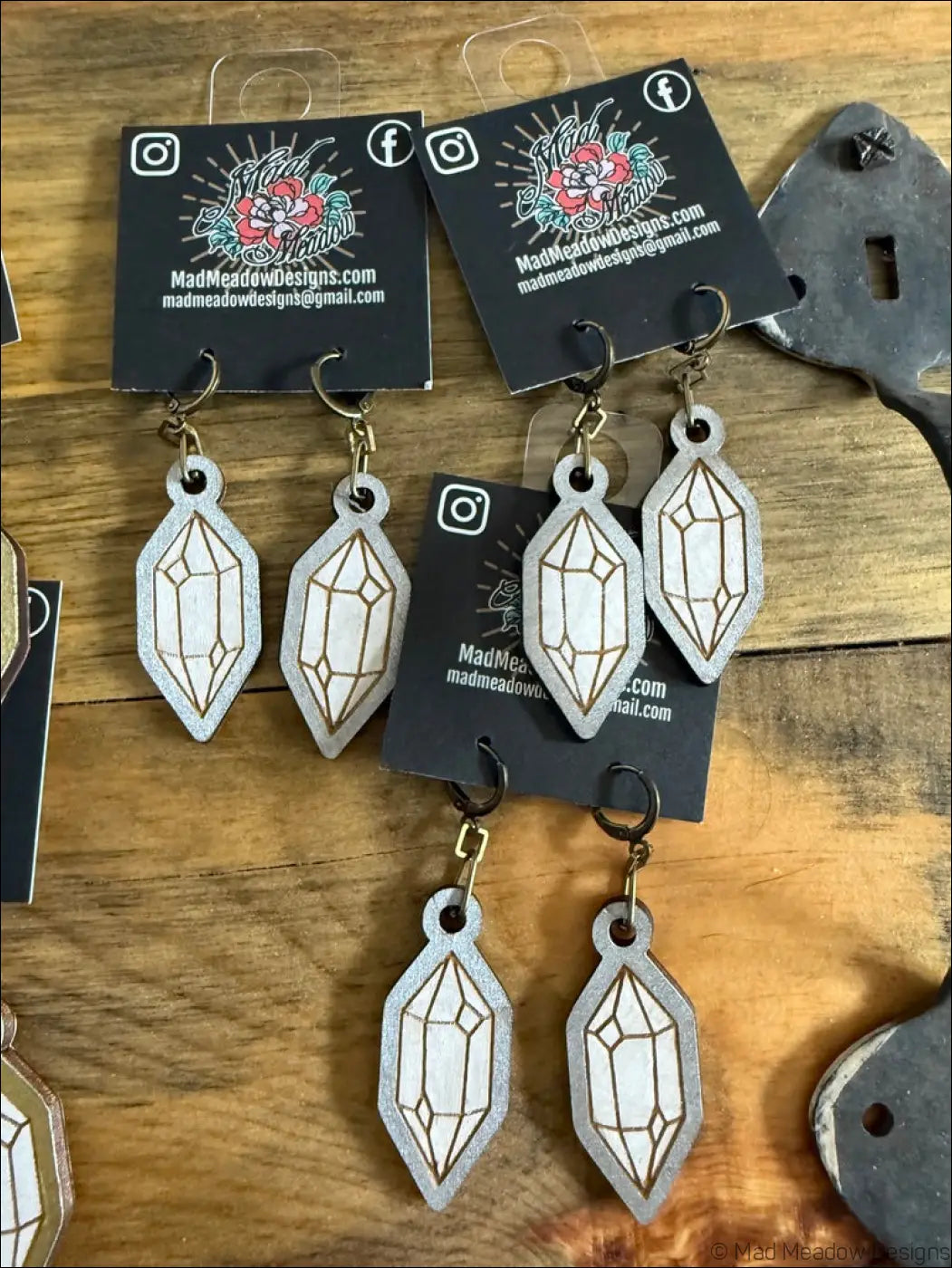 Silver glittery crystal-shaped wooden earrings with gold line detailing hand-painted for a stylish look
