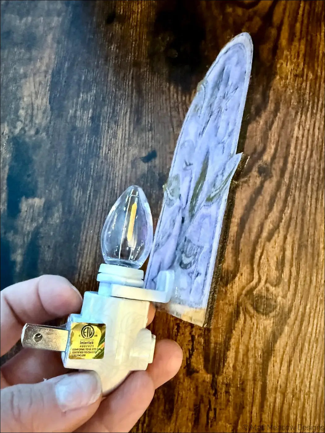 White plastic night light with clear glass bulb and marbled purple cover featuring elegant branch and twinkling stars design