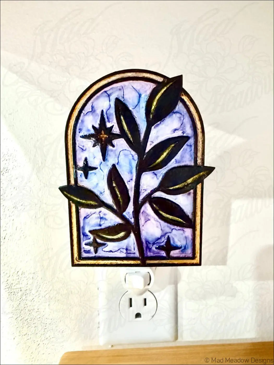 Arched stained glass night light with elegant branch and twinkling stars design on purple and blue marbled background