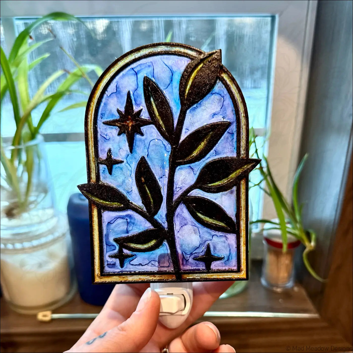 Elegant branch and twinkling stars night light with arched gold frame and stained-glass blue purple design