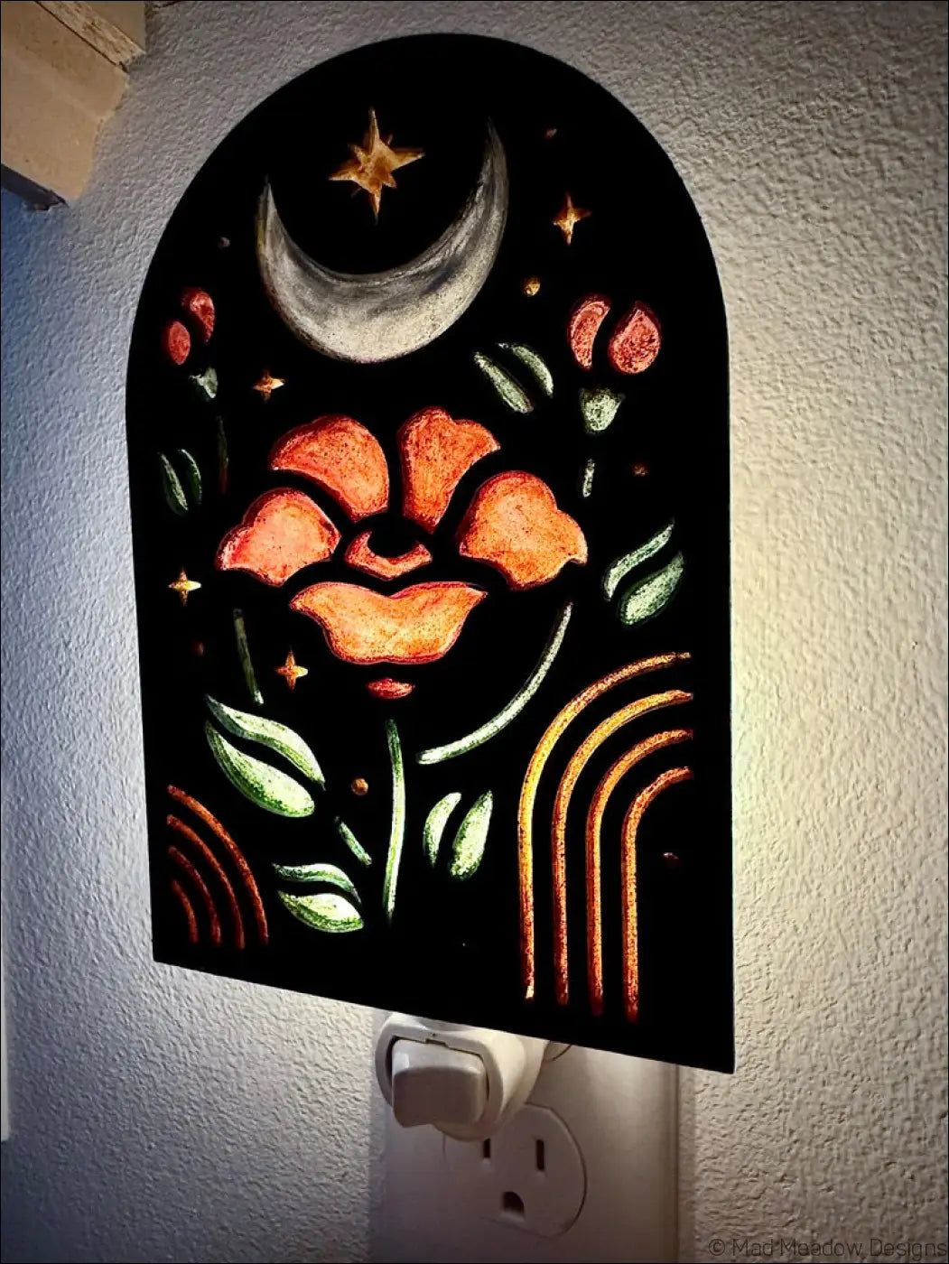 Black arched night light with glowing orange elegant flowers moon stars and rainbow accents perfect for cozy decor