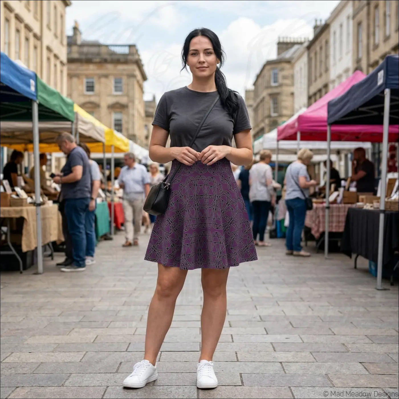 A woman wearing a dark purple elemental column pattern women’s skater skirt with a geometric design hand wash care instructions