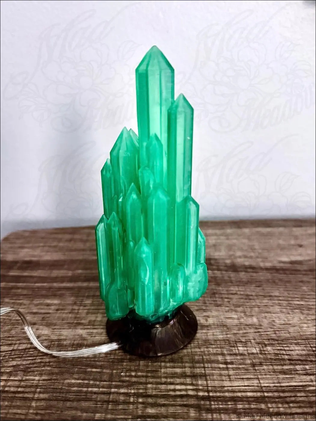 Emerald green crystal cluster lamp with sleek black base hand inked 3d printed for a mystical sanctuary vibe