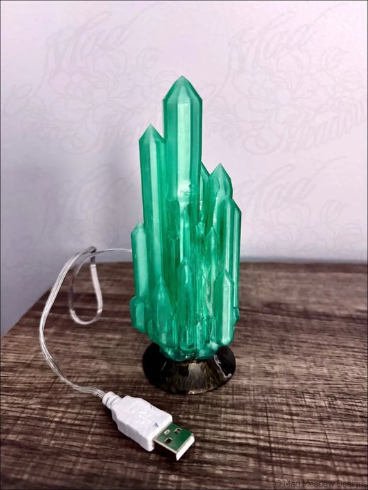 Emerald-green crystal-shaped usb lamp with black base hand-inked 3d printed for mystical sanctuary ambiance