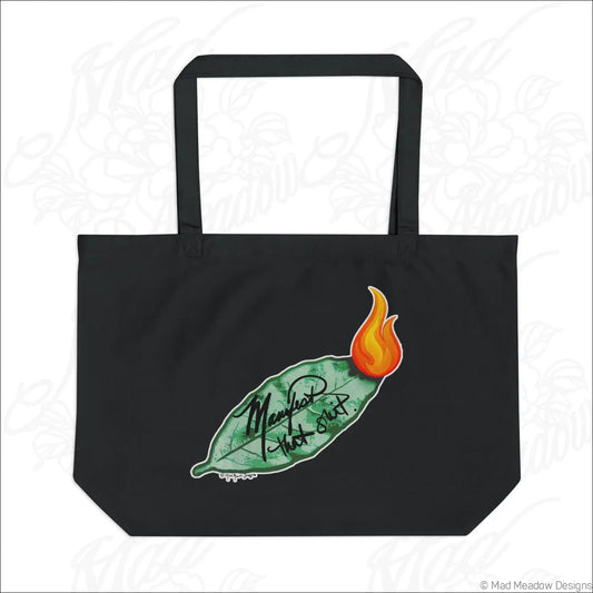 Black organic cotton tote bag with green bay leaf and orange flame featuring manifold that shit cursive care instructions