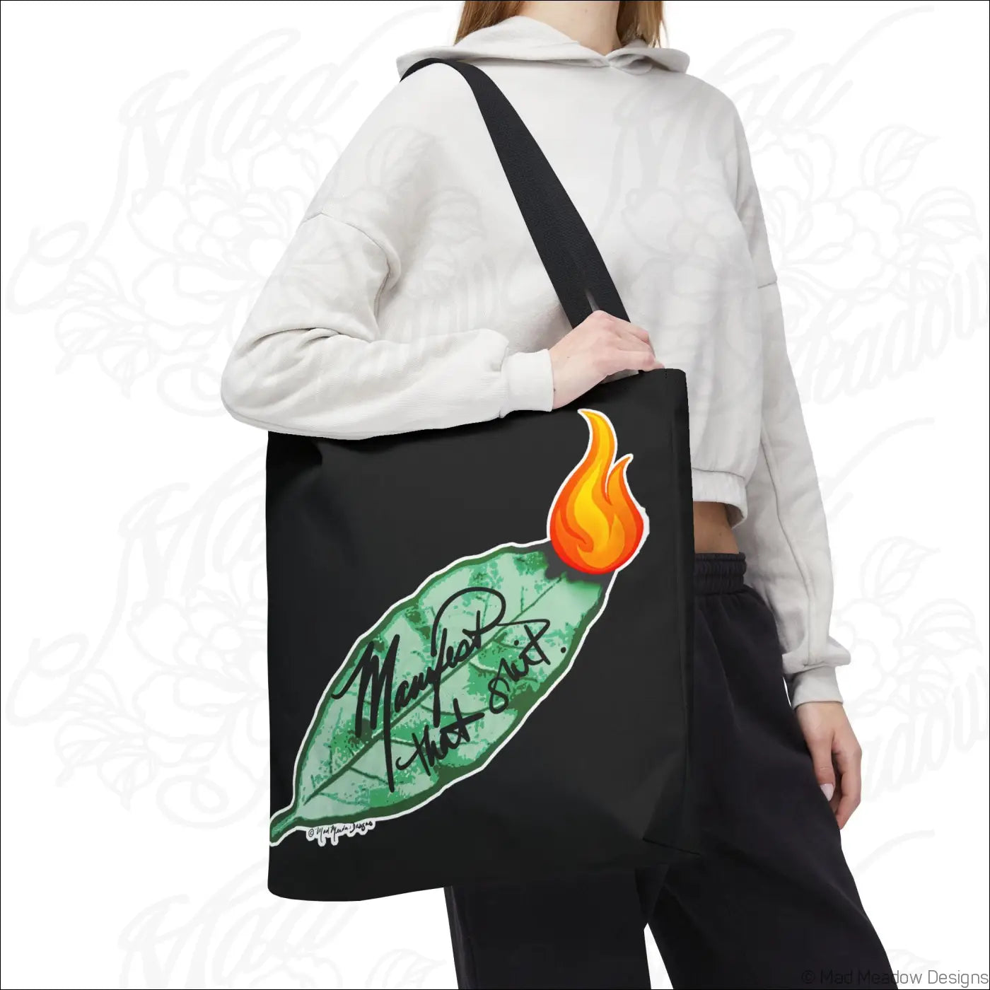 Black canvas flaming bay leaf tote bag with boxed corners and care instructions featuring vibrant flame design and cursive text