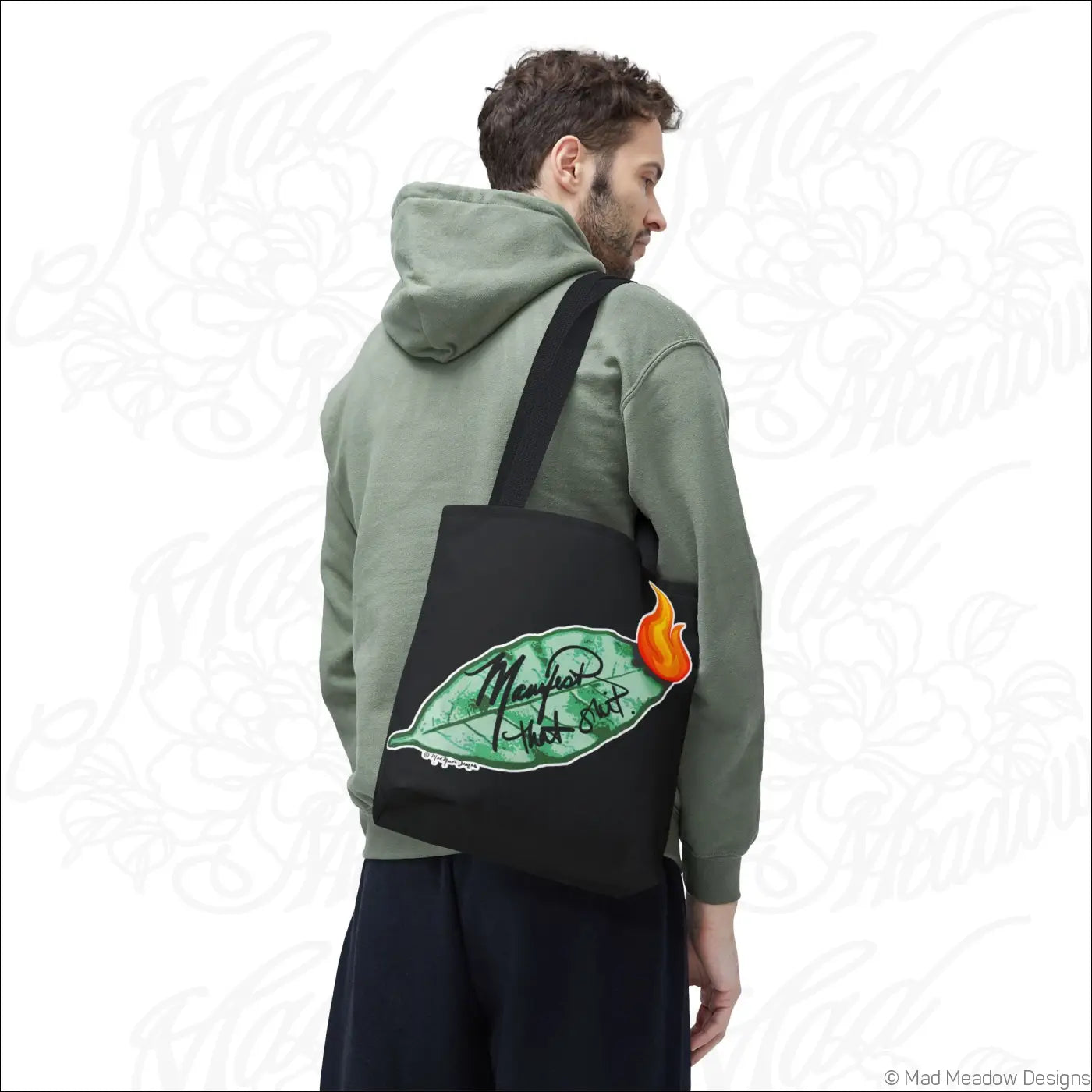 Black canvas eco tote bag with bay leaf and orange flame design manny’s hot shot script and boxed corners care instructions