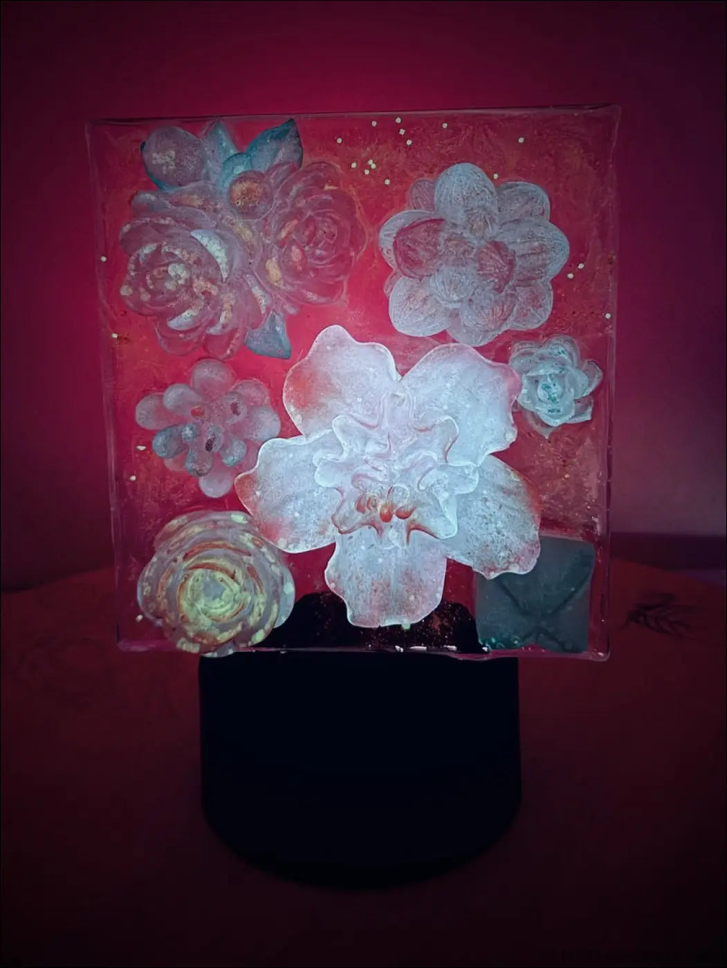 A translucent square glass pastel garden nightlight with embossed white and blue flowers and dreamy hues glitter accents