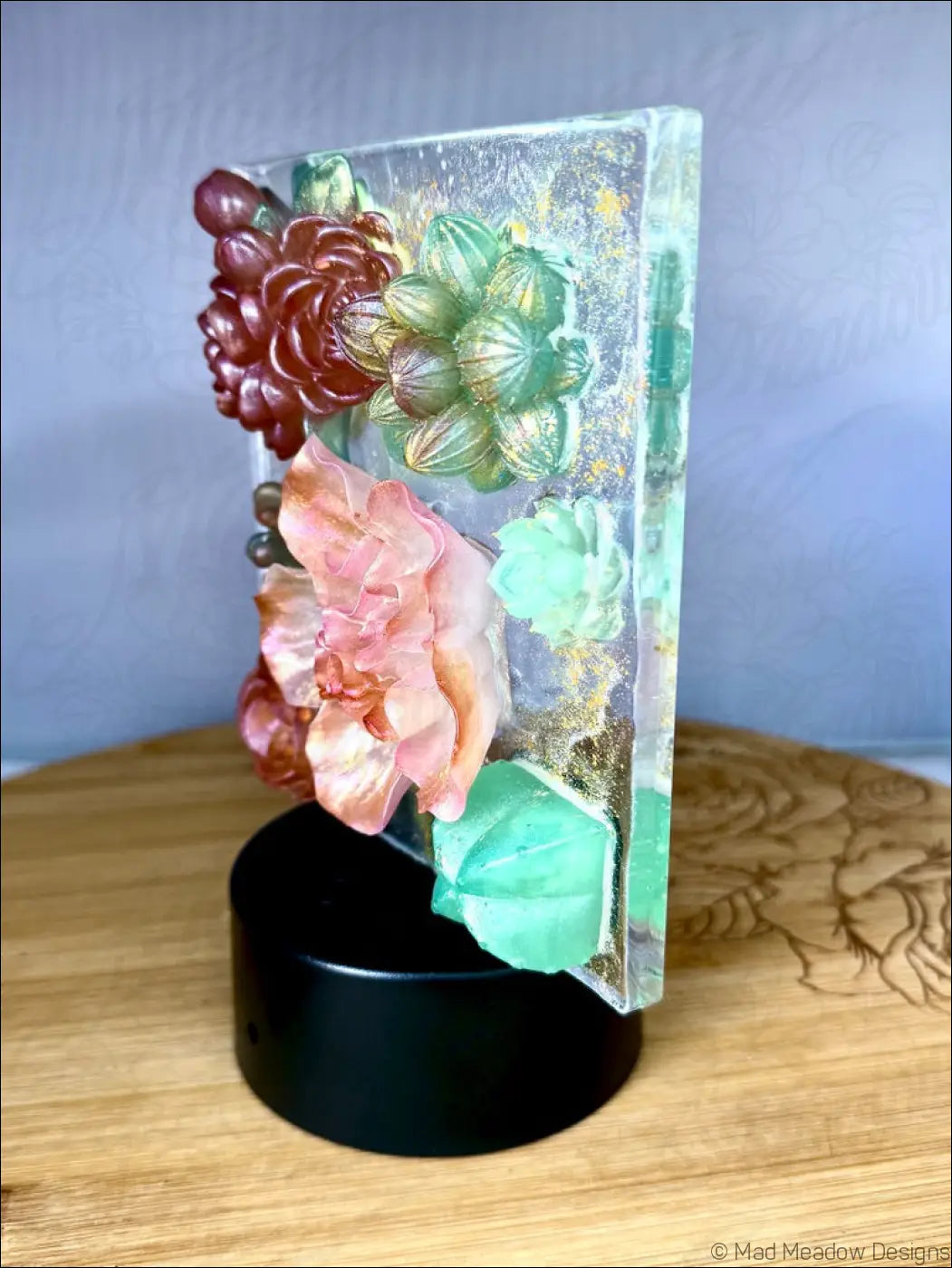 A translucent resin pastel garden nightlight with vibrant pink green and burgundy flowers in dreamy hues