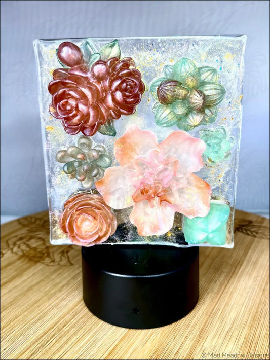 A square glass pastel garden nightlight with raised rose gold, peach, mint green, and amber floral and succulent designs