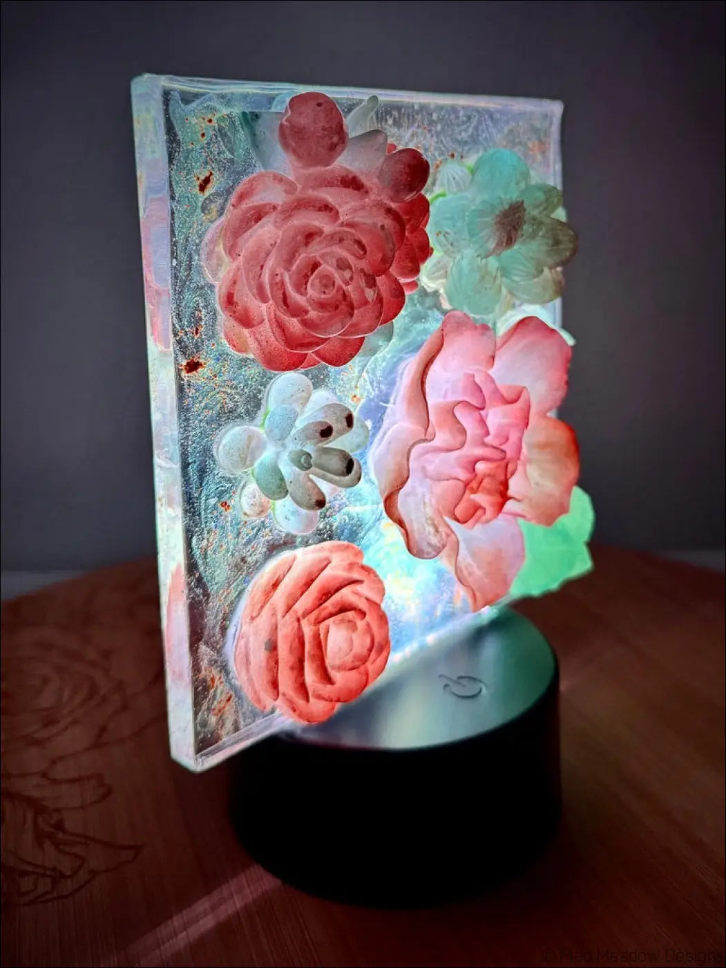 A glowing resin pastel garden nightlight with 3d floral designs in soft pink and mint green dreamy hues