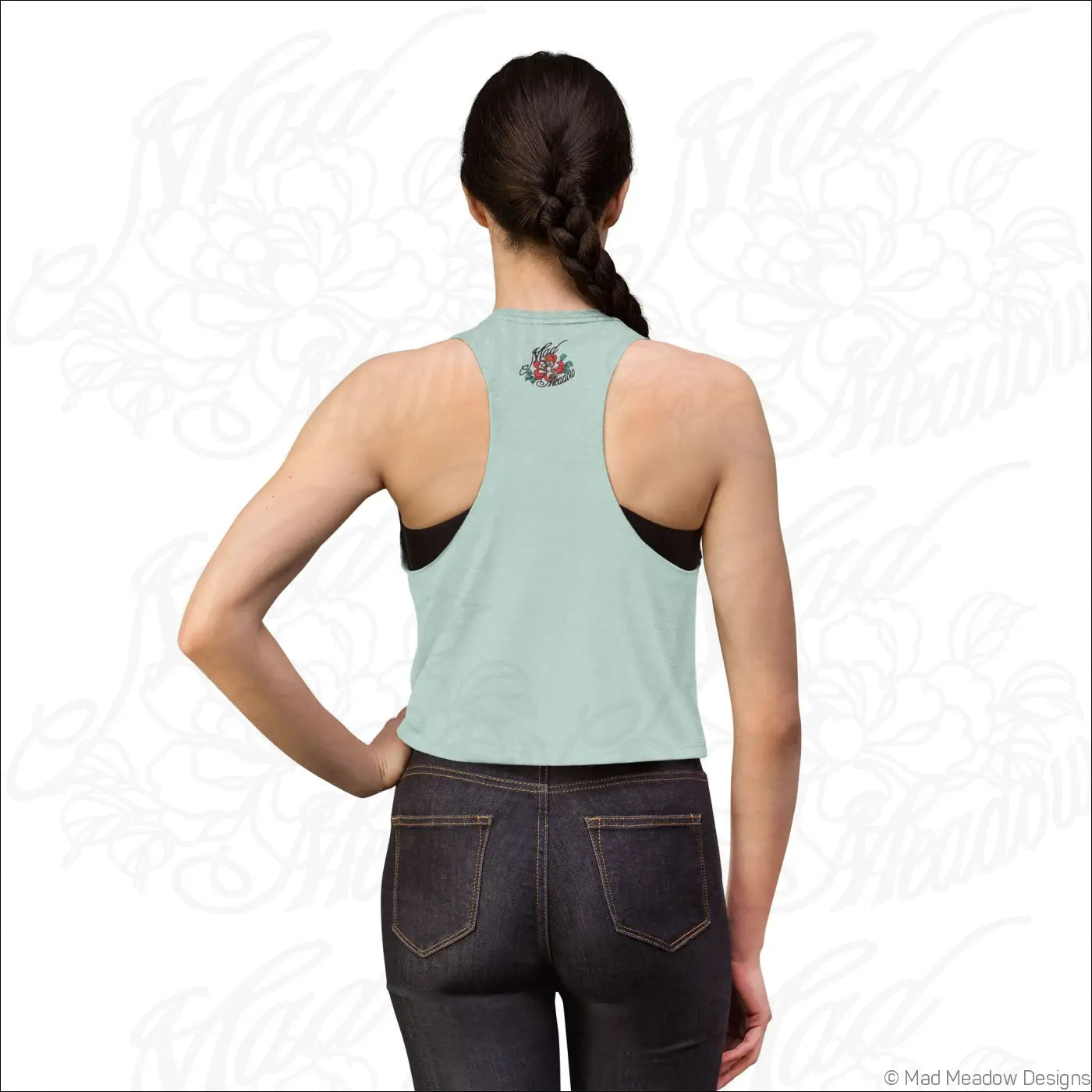 Light green racerback crop top with black side panels and small floral embroidery on back made of combed ring spun cotton