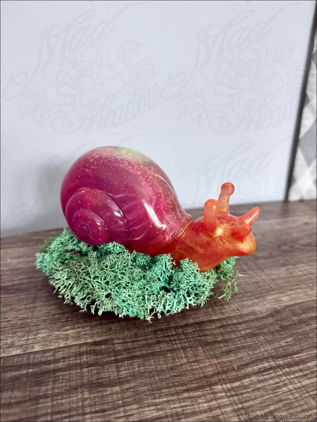 Giant pink and gold resin snail figurine with a glossy speckled shell sitting on green moss for rgb usb or battery light