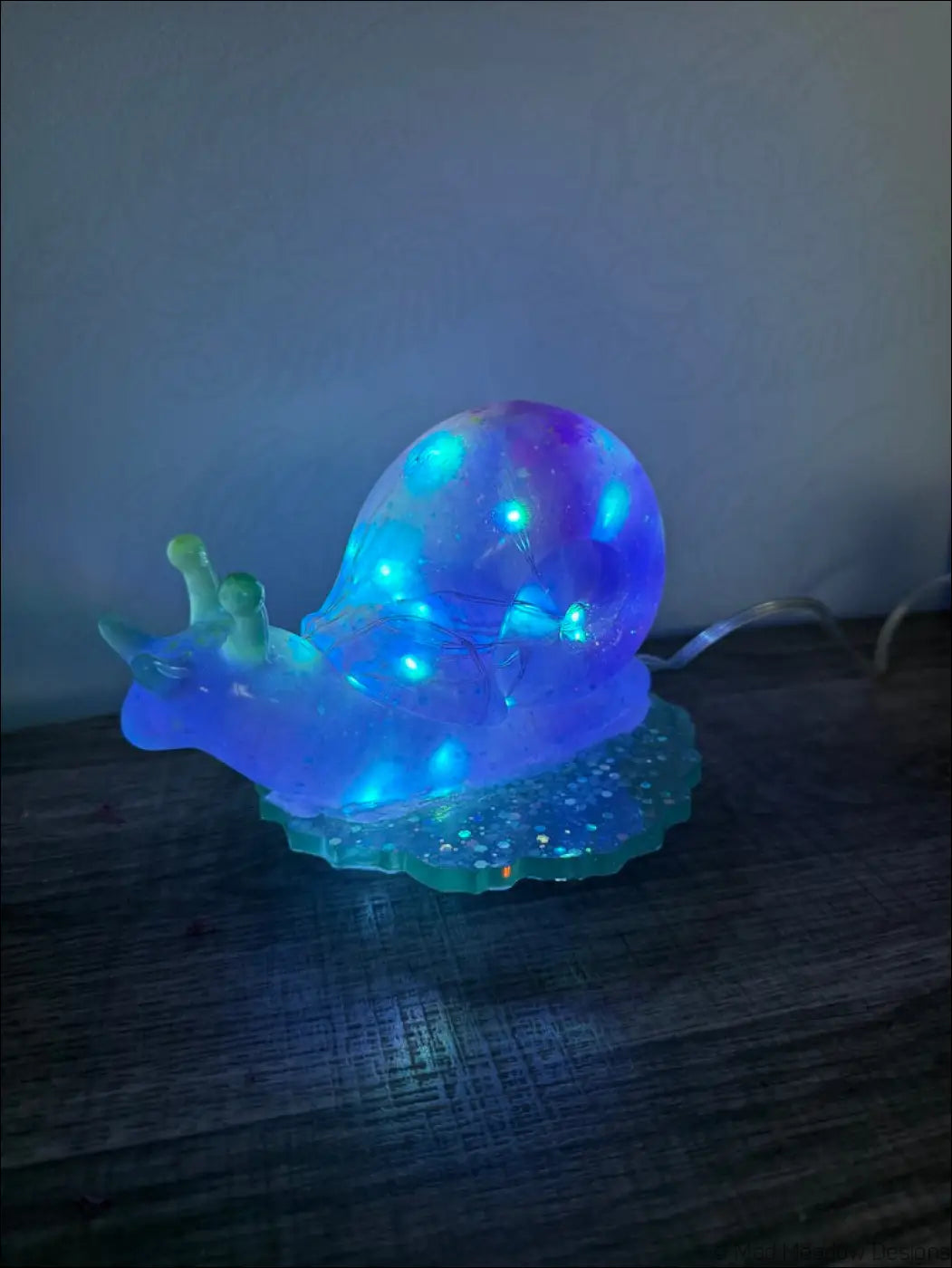 Giant purple snail light rgb usb or battery with glowing blue and purple led translucent shell and green antennae on glittery base