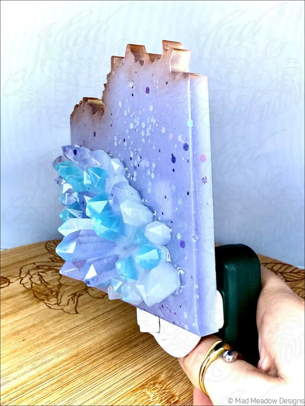 Lavender resin bookend with a glowing crystal cluster of translucent blue crystals as a wall night light plug-in base