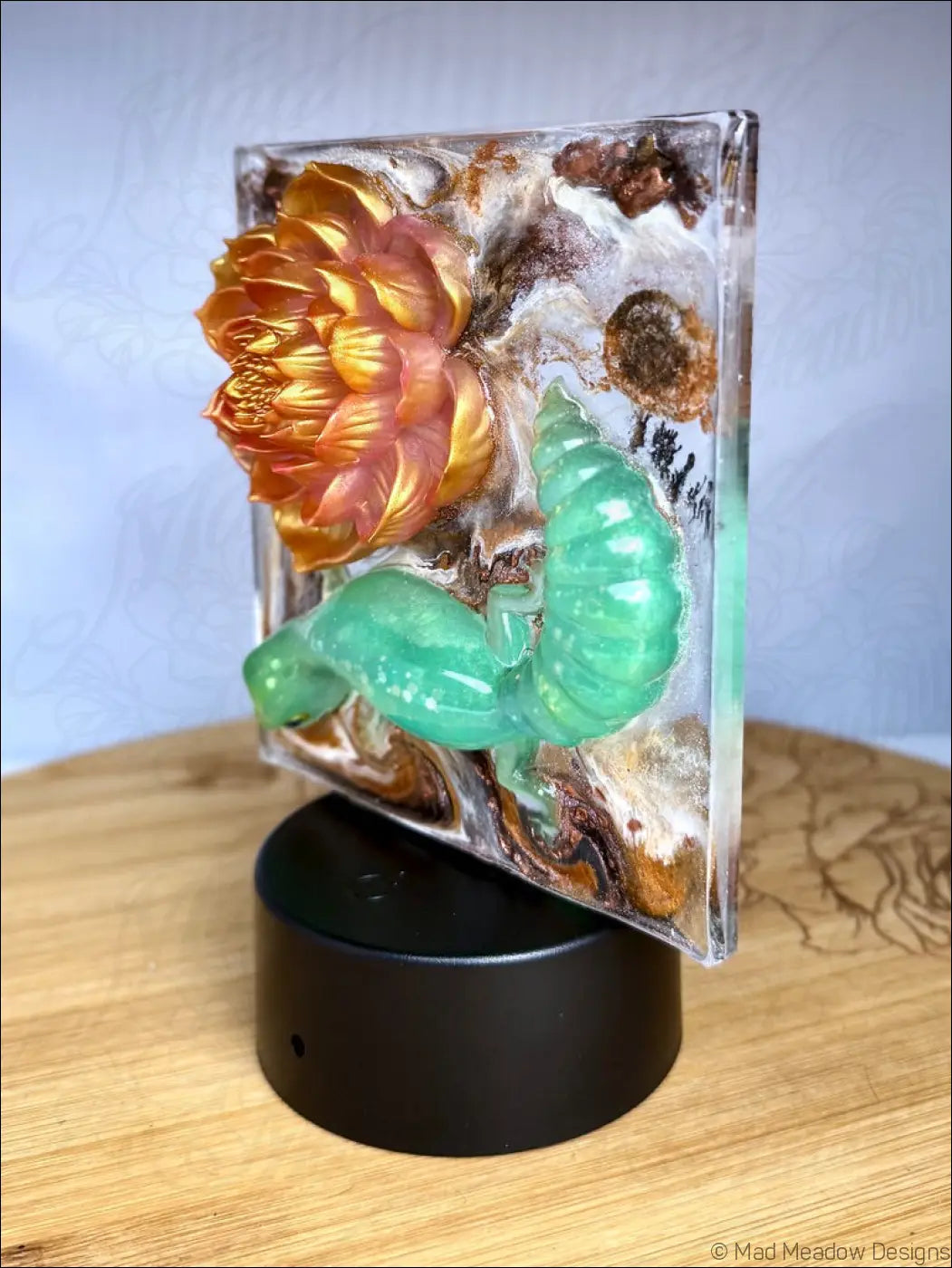 Vibrant translucent resin glowing gecko night light with a golden-orange flower and shimmering gold accents