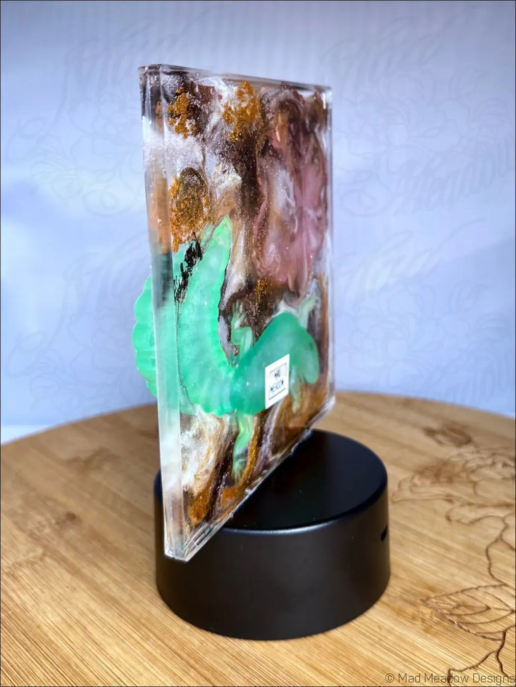 Transparent resin glowing gecko nightlight with swirling amber pink green hues and shimmering gold accents leaf design