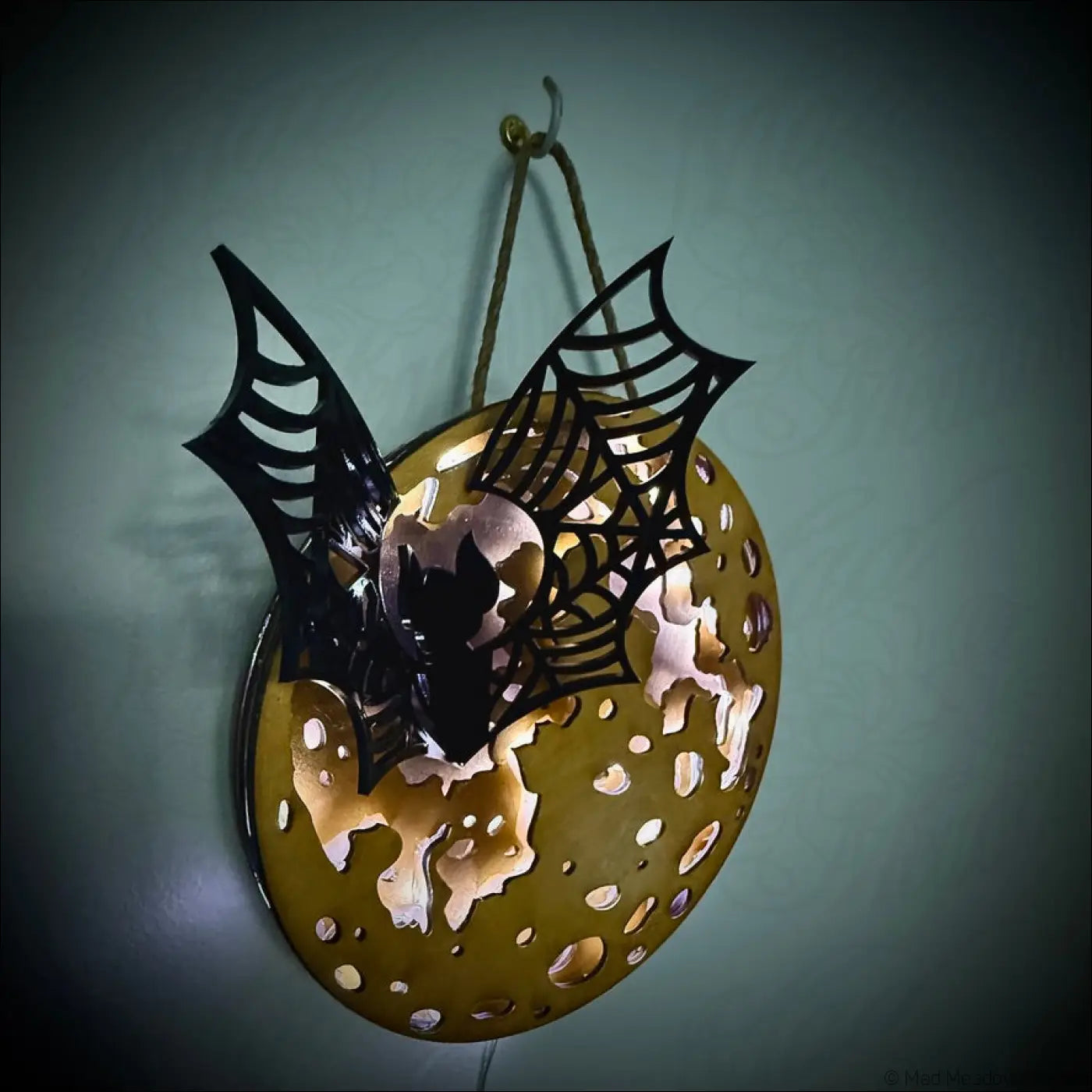 Glowing golden moon and bat hanging wall light with enchanting laser-cut wood bat and spiderweb on moon light fixture