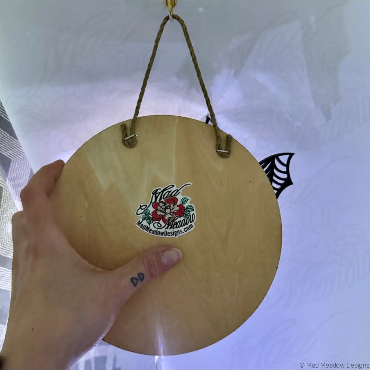 Light-colored wooden glowing golden moon and bat hanging wall light with enchanting laser-cut wood and rope hangers