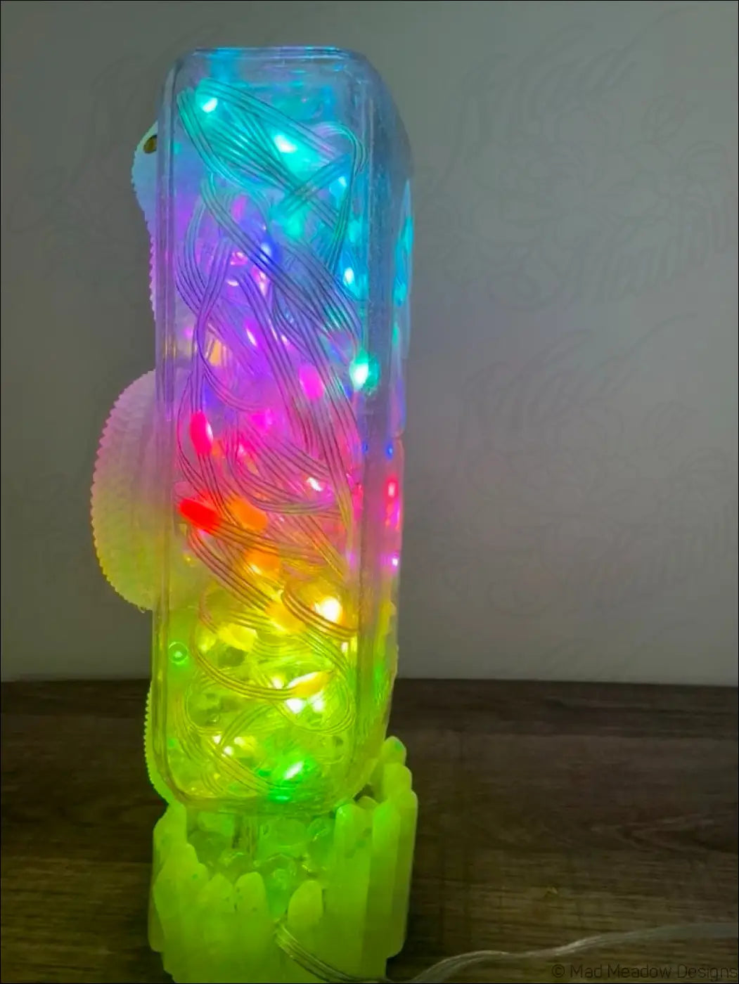 Glowing snake usb lamp with clear plastic body and colorful led swirl patterns on crystal dish base
