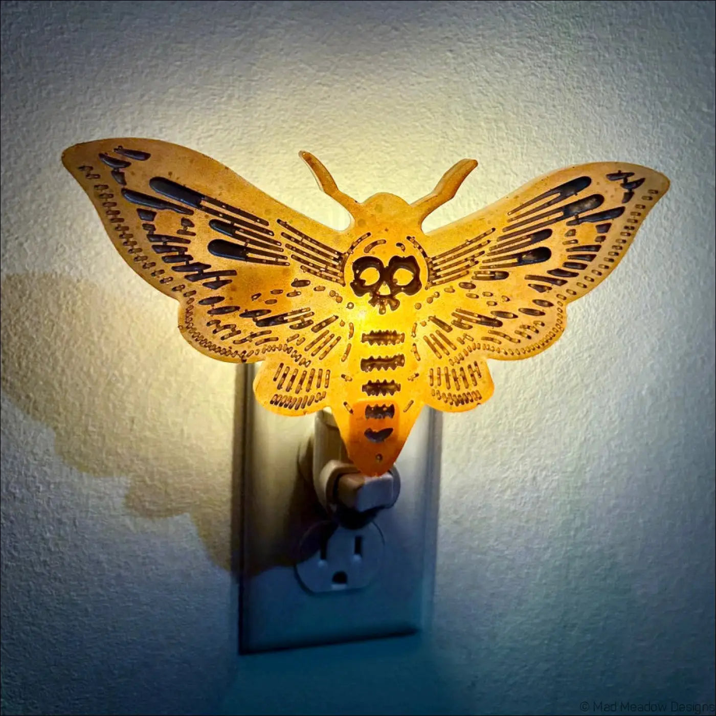 Golden death moth resin wall night light with skull design and intricate cut-outs perfect as a feather wall night light