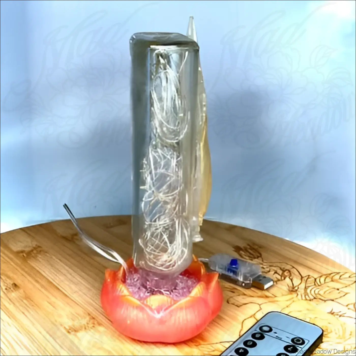 Transparent glass apothecary bottle with silver coils on red-orange lotus flower base antique glass usb light