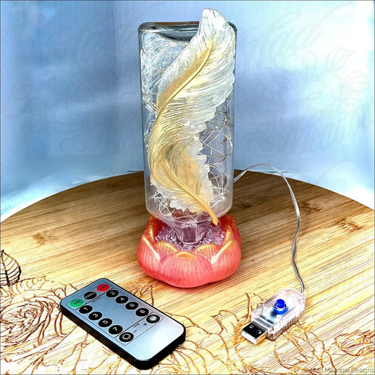 A translucent antique glass apothecary bottle with golden feather design on red-orange lotus base usb light